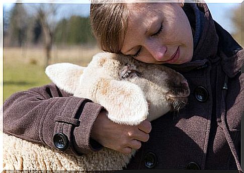 Woman hugging a lamb